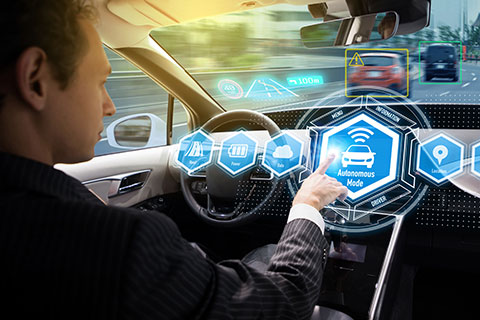 Driver activating "Autonomous Mode" on a futuristic vehicle dashboard.