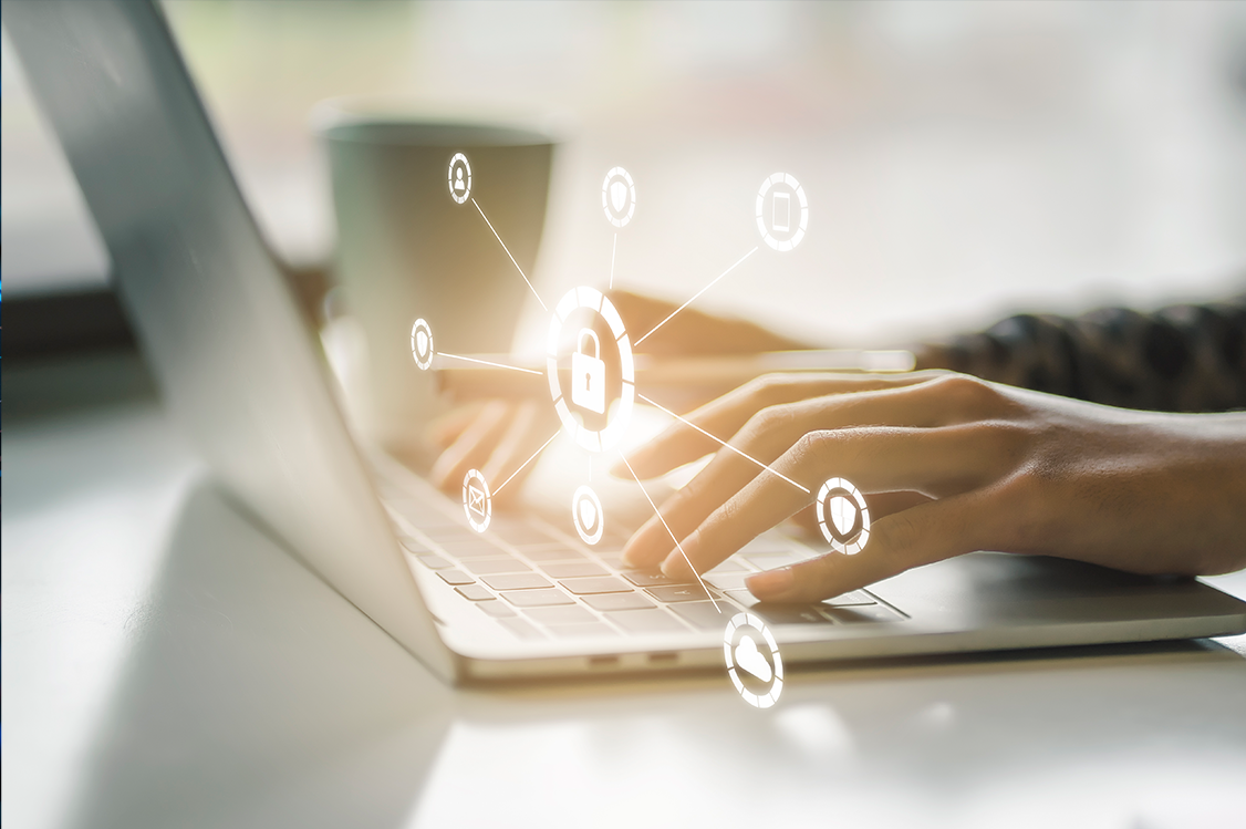 A person typing on a laptop with a glowing padlock and network icons superimposed, symbolizing digital security.
