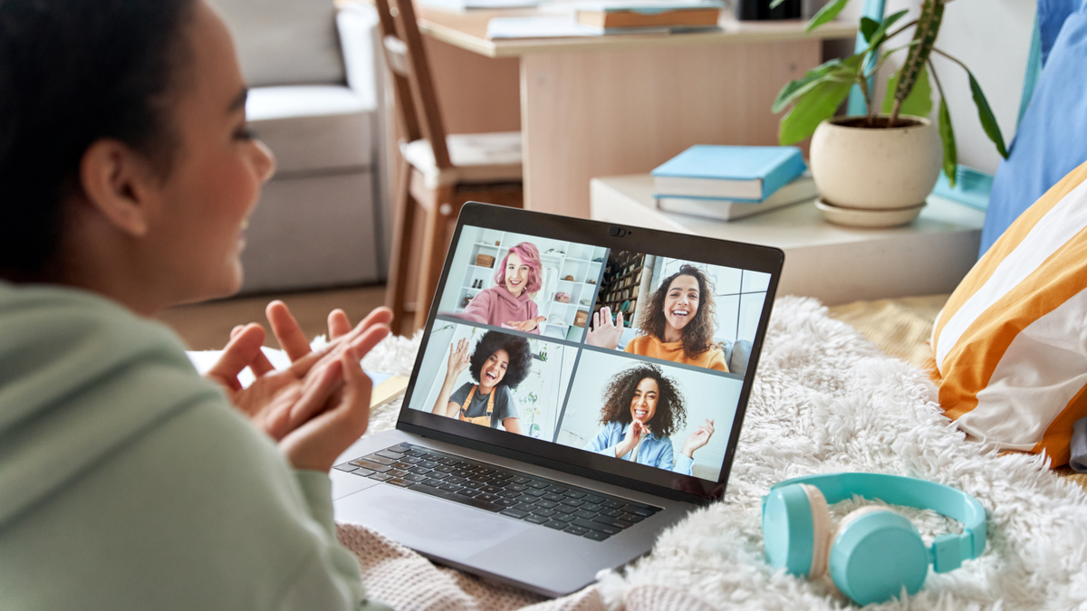 Woman talking to friends via online video conference.